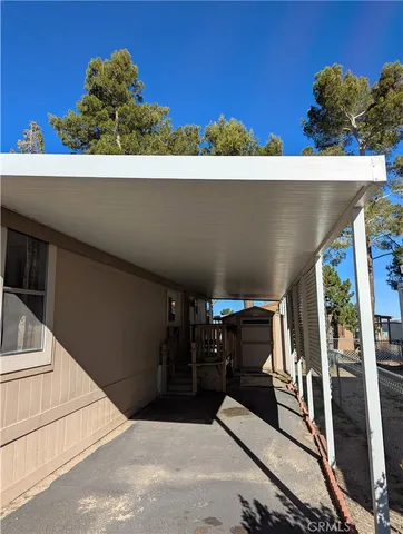 a front view of a house with outdoor seating and flowers