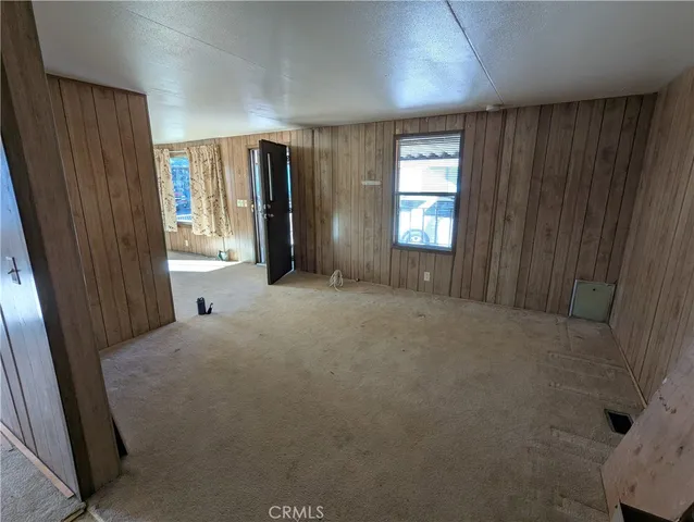 a view of a hallway with furniture and windows