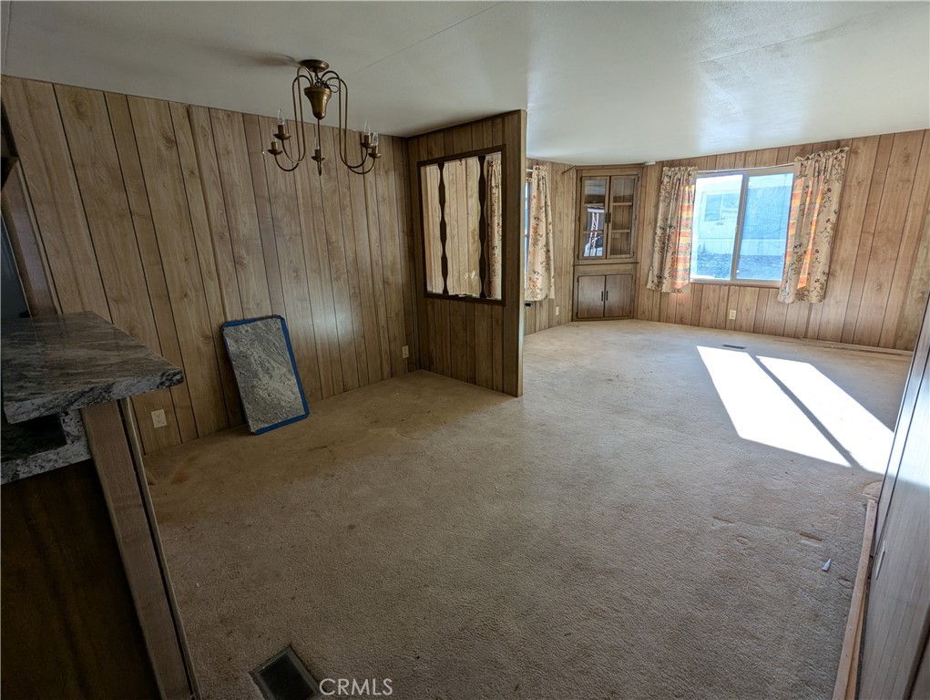 10200 Johnson Road, Unit 36 Phelan, CA 92371 - Photo 6 of 22 a view of a hallway with furniture and windows