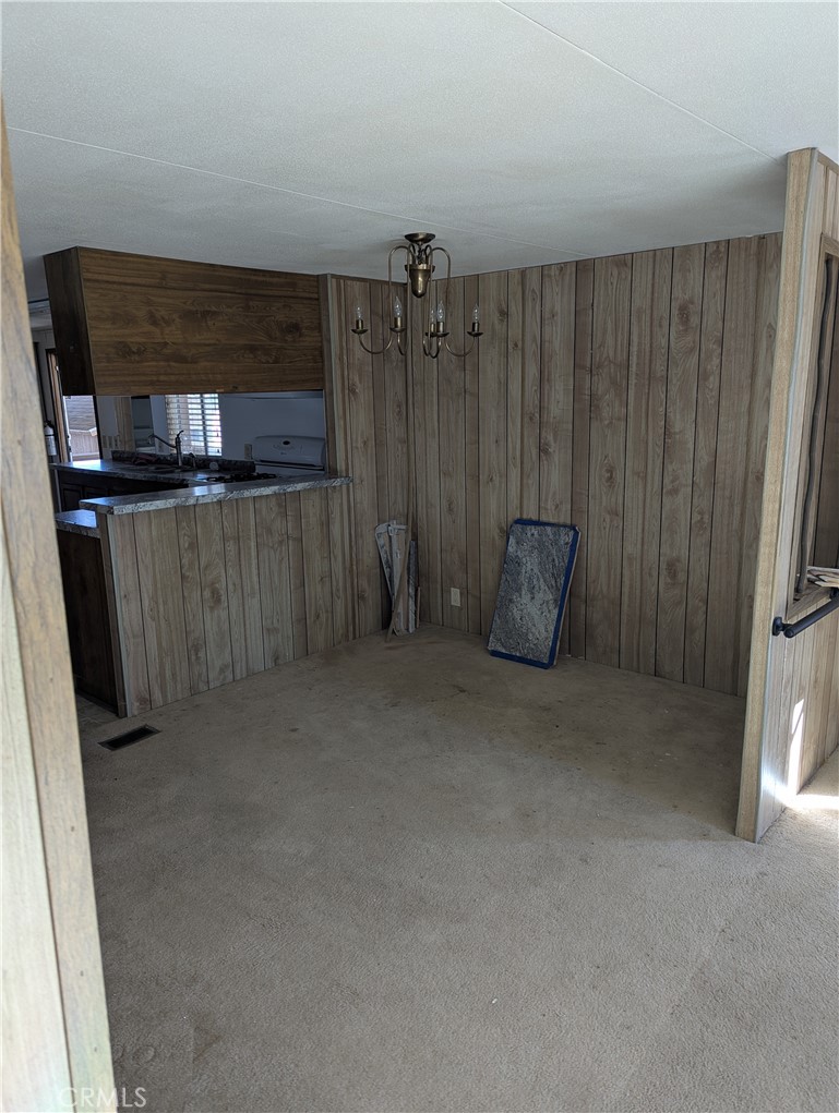 10200 Johnson Road, Unit 36 Phelan, CA 92371 - Photo 7 of 22 a kitchen with a refrigerator and cabinets
