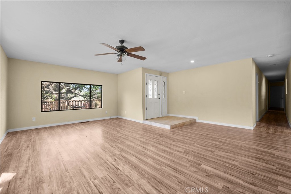 29570 Butterfield Way Tehachapi, CA 93561 - Photo 11 of 50 a view of an empty room with a window and wooden floor