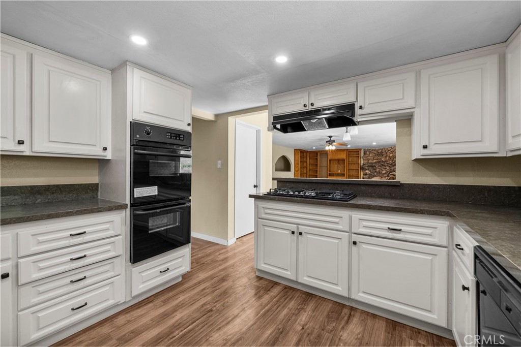 29570 Butterfield Way Tehachapi, CA 93561 - Photo 17 of 50 a kitchen with stainless steel appliances granite countertop a stove a sink and a refrigerator