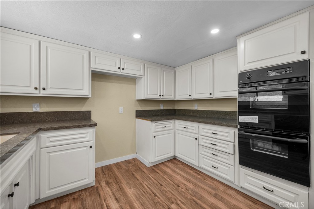 29570 Butterfield Way Tehachapi, CA 93561 - Photo 18 of 50 a kitchen with granite countertop white cabinets and stainless steel appliances