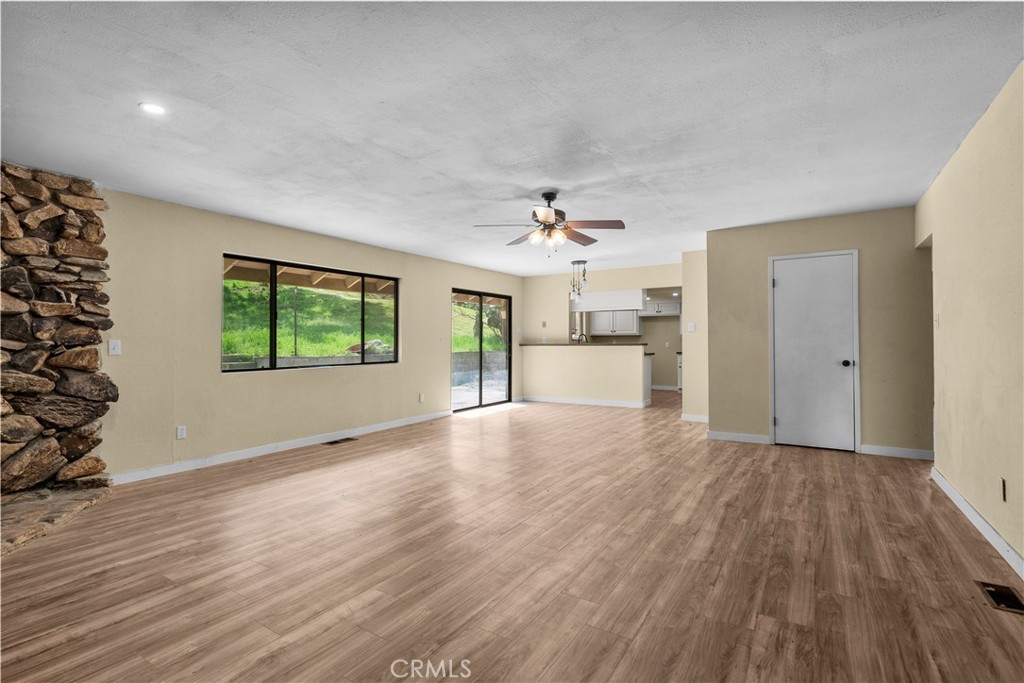 29570 Butterfield Way Tehachapi, CA 93561 - Photo 22 of 50 wooden floor in an empty room with a window
