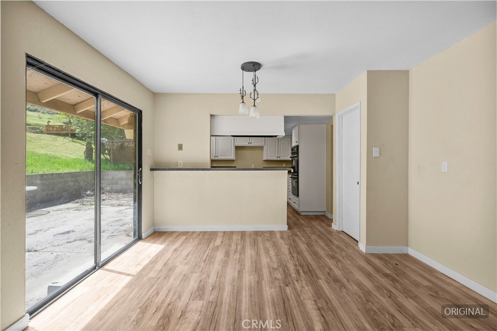 29570 Butterfield Way Tehachapi, CA 93561 - Photo 26 of 50 a room with a wooden floor and large windows