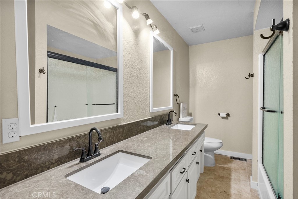 29570 Butterfield Way Tehachapi, CA 93561 - Photo 28 of 50 a bathroom with a granite countertop sink and a mirror