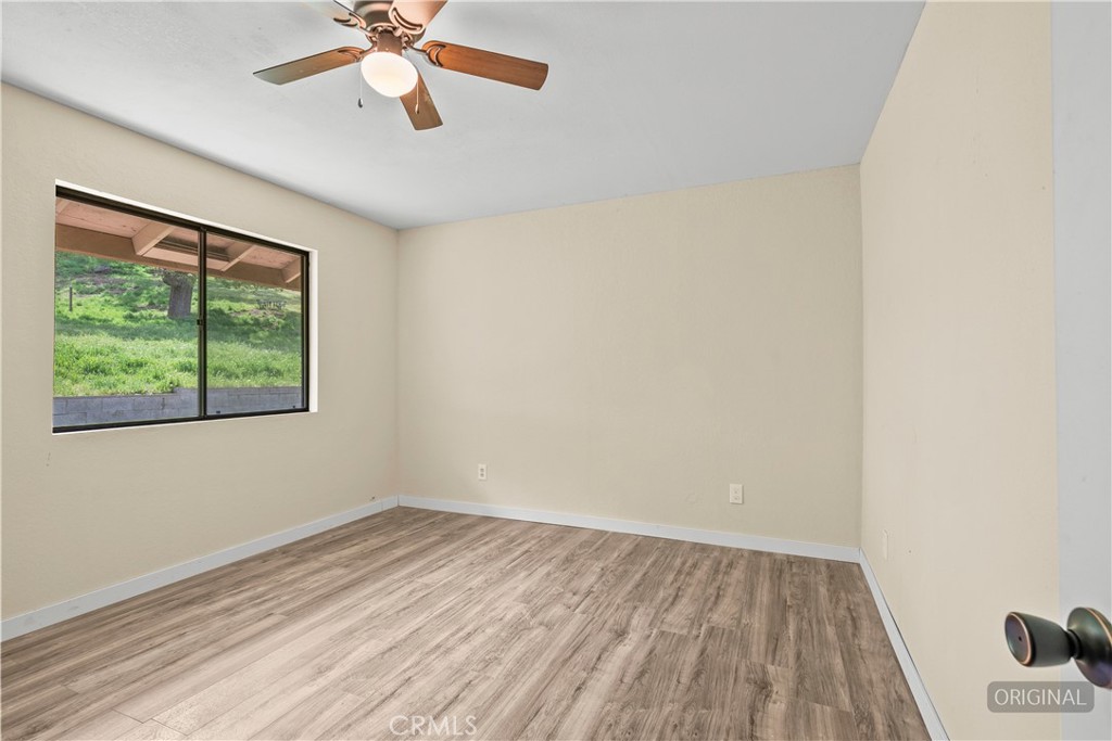 29570 Butterfield Way Tehachapi, CA 93561 - Photo 30 of 50 an empty room with a window and a ceiling fan