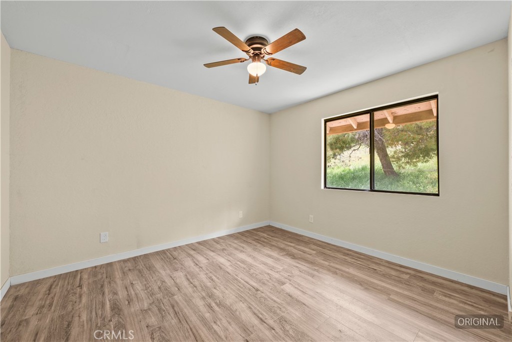 29570 Butterfield Way Tehachapi, CA 93561 - Photo 33 of 50 wooden floor in an empty room with a window