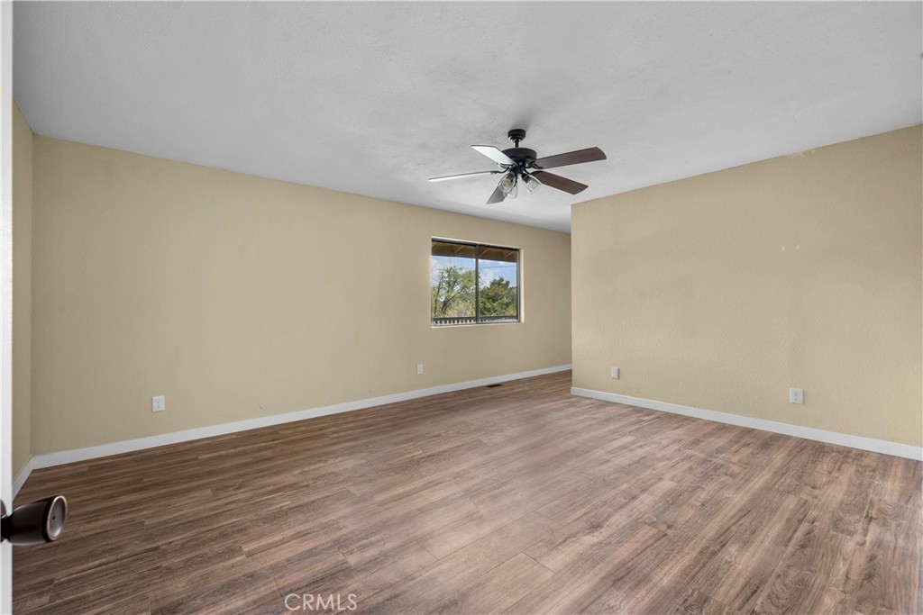 29570 Butterfield Way Tehachapi, CA 93561 - Photo 36 of 50 a view of an empty room with a window and a fireplace