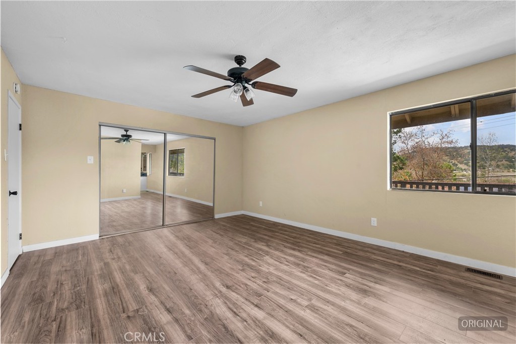 29570 Butterfield Way Tehachapi, CA 93561 - Photo 39 of 50 a view of empty room with wooden floor and fan
