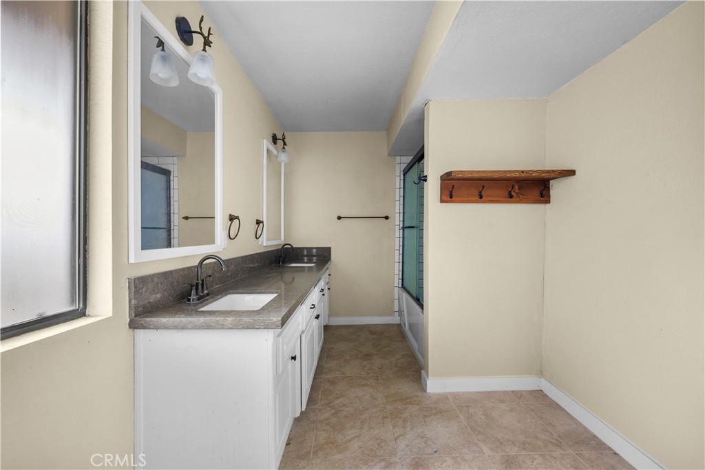 29570 Butterfield Way Tehachapi, CA 93561 - Photo 41 of 50 a bathroom with a granite countertop sink and a mirror