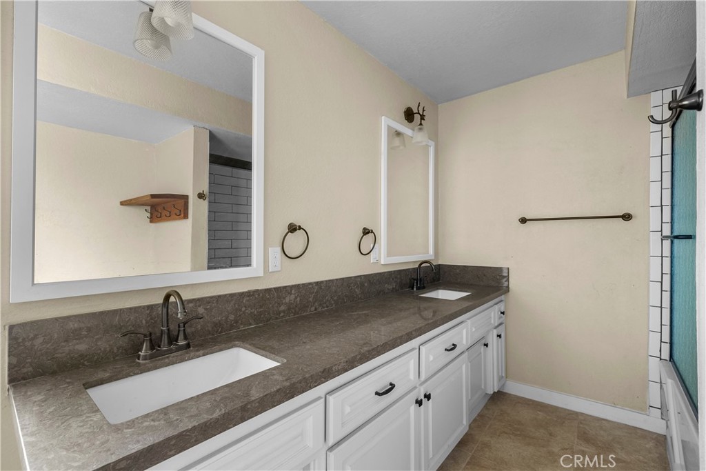 29570 Butterfield Way Tehachapi, CA 93561 - Photo 42 of 50 a bathroom with a granite countertop sink and a mirror