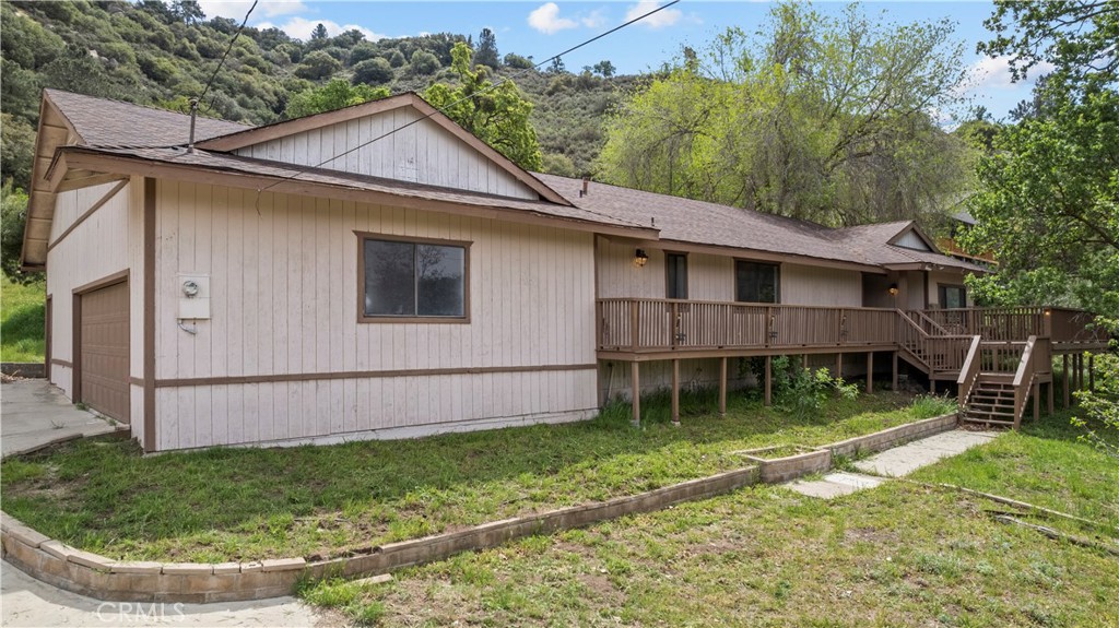 29570 Butterfield Way Tehachapi, CA 93561 - Photo 7 of 50 a view of a house with a backyard and a patio