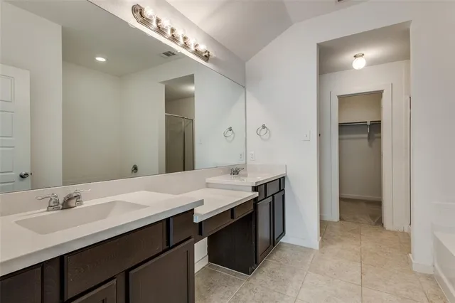 a spacious bathroom with a double vanity sink and a mirror
