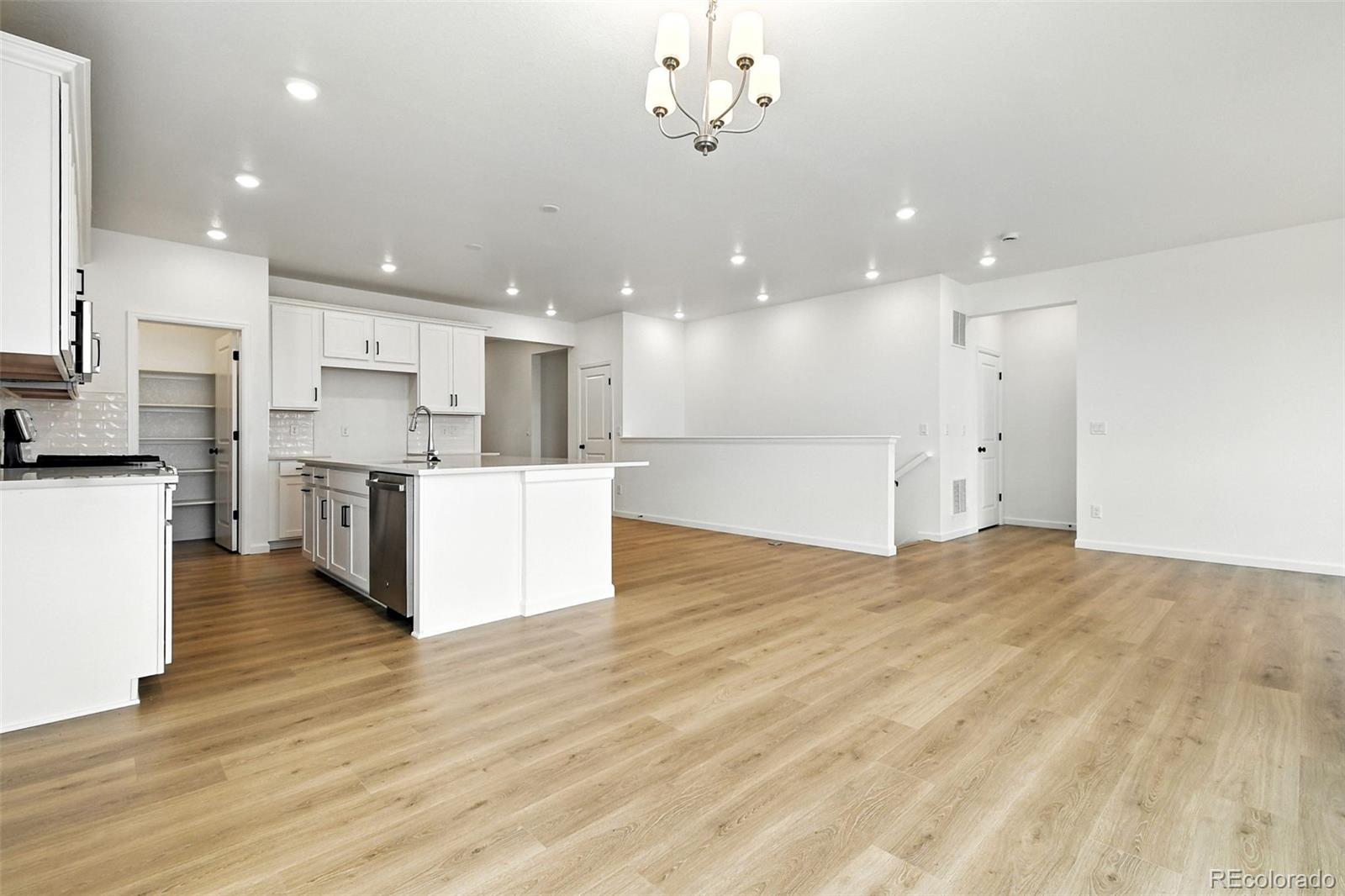 17075 West 92nd Loop Arvada, CO 80007 - Photo 12 of 33 a view of a kitchen with kitchen island a sink stainless steel appliances and cabinets