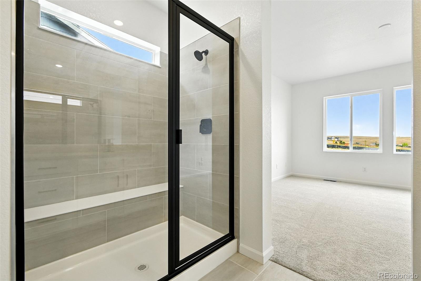 17075 West 92nd Loop Arvada, CO 80007 - Photo 20 of 33 a bathroom with a bathtub and shower