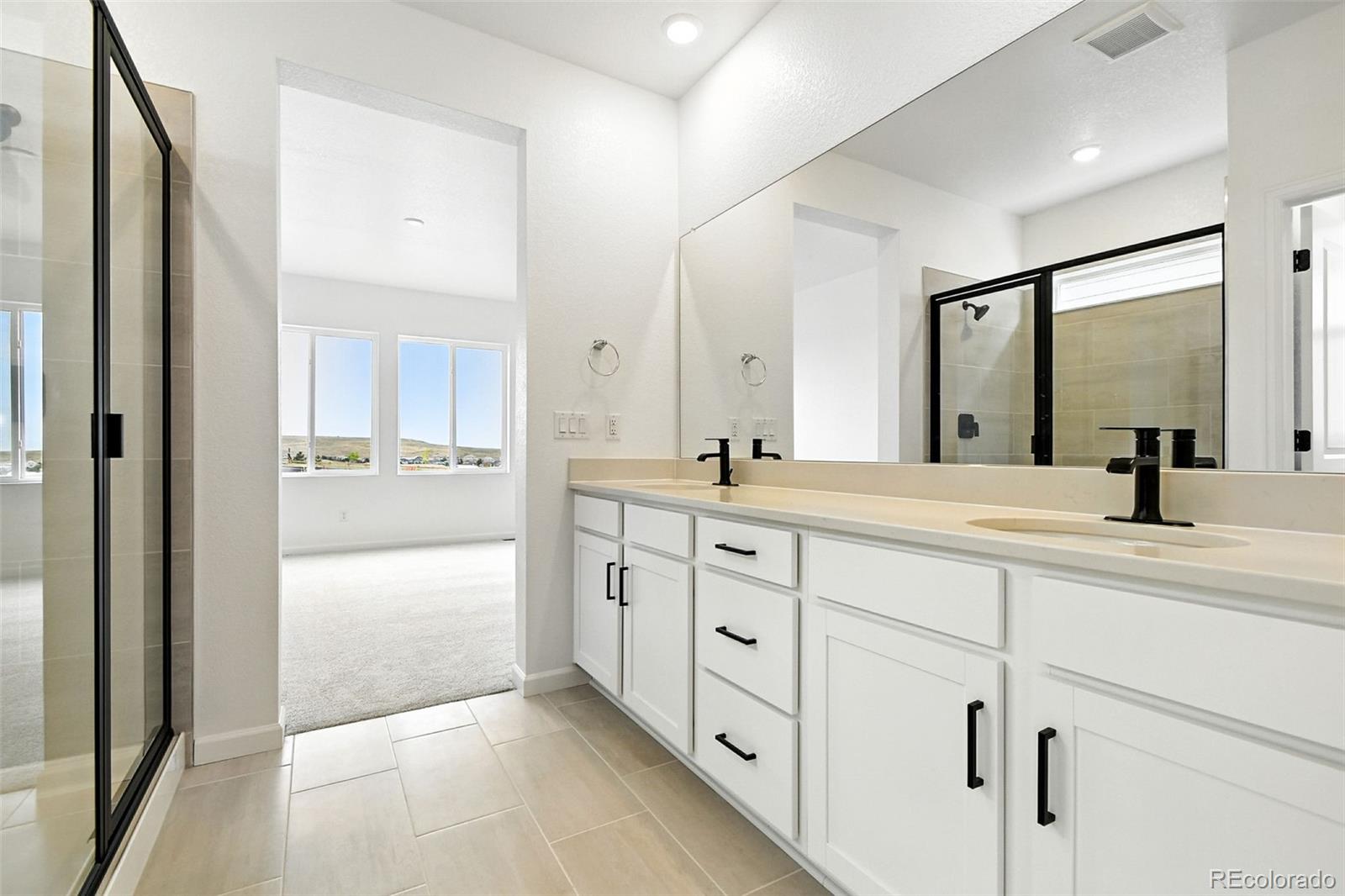 17075 West 92nd Loop Arvada, CO 80007 - Photo 5 of 33 a spacious bathroom with double sink and a mirror