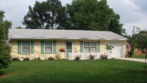 a view of a house with garden and plants