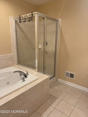 a bathroom with a tub and a shower