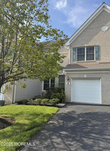 a front view of house with yard and trees