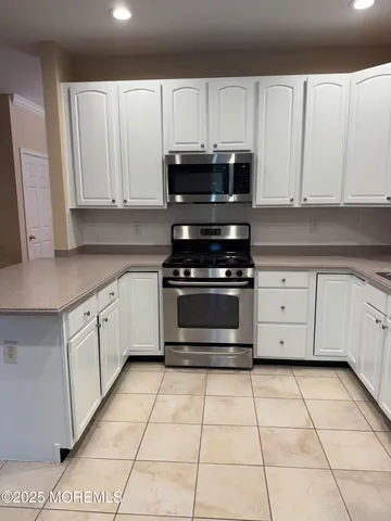 a kitchen with cabinets and appliances