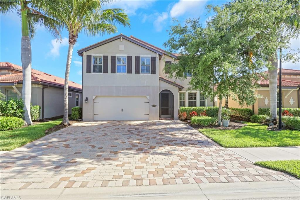 16309 Aberdeen Way Naples, FL 34110 - Photo 2 of 34 a front view of a house with a yard and garage