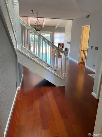 a view of entryway and hall with wooden floor