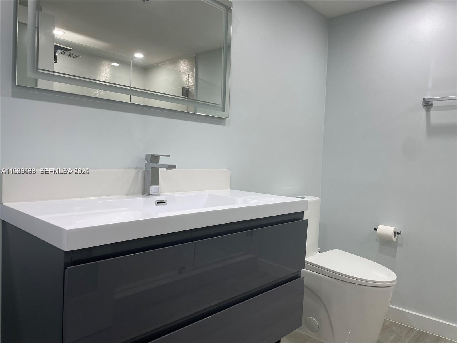 2031 Renaissance Boulevard, Unit 101 Miramar, FL 33025 - Photo 12 of 23 a bathroom with a sink toilet and a mirror