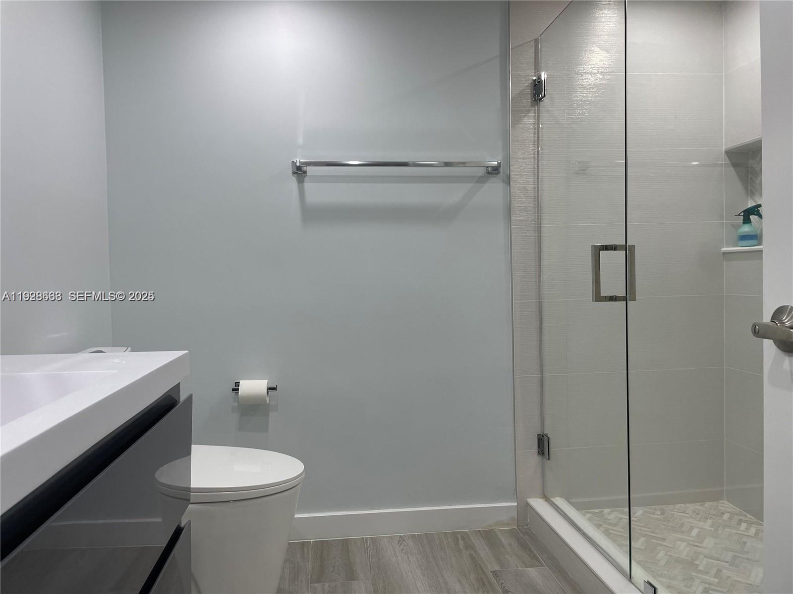 2031 Renaissance Boulevard, Unit 101 Miramar, FL 33025 - Photo 13 of 23 a bathroom with a toilet a sink and shower