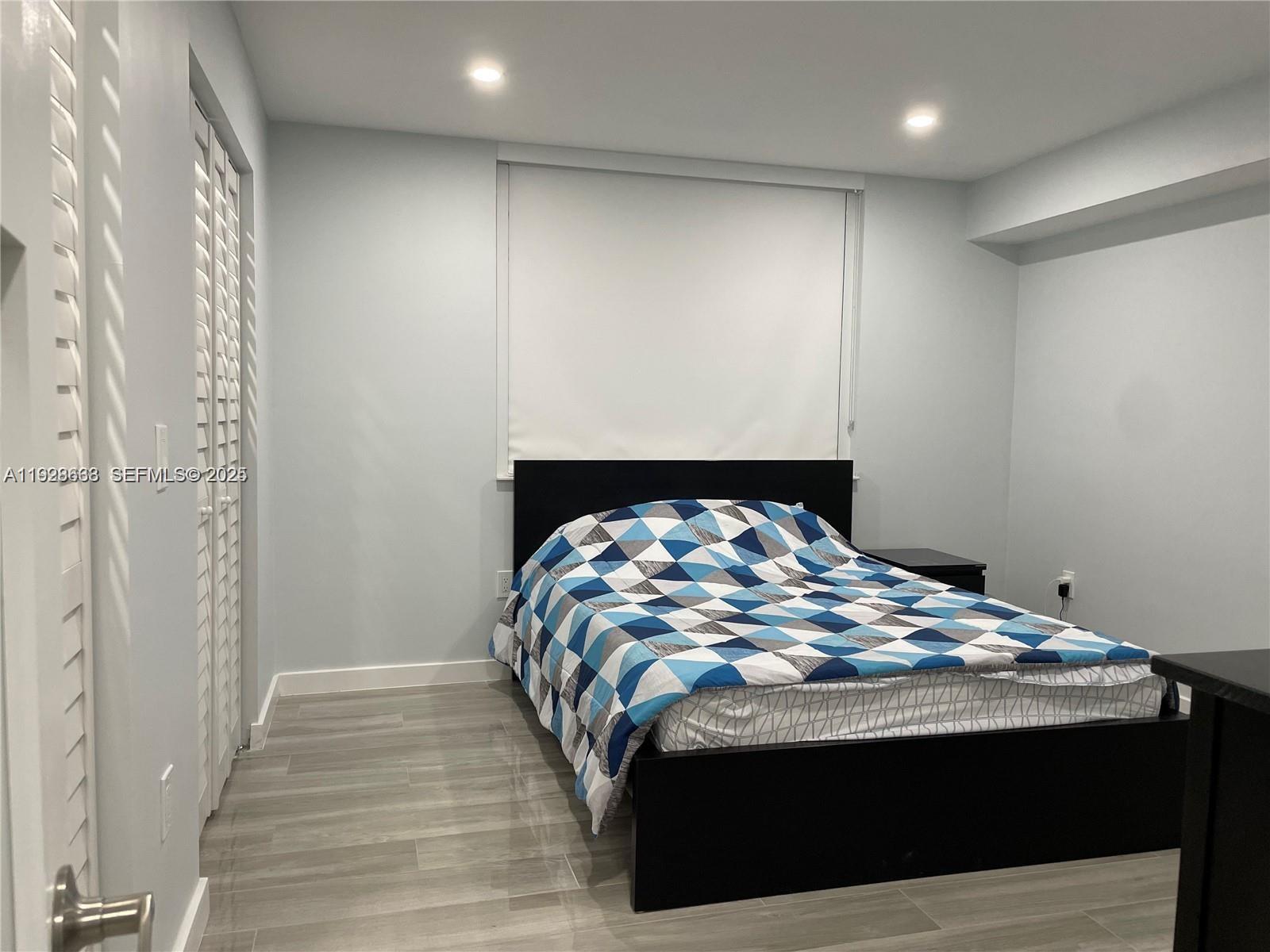 2031 Renaissance Boulevard, Unit 101 Miramar, FL 33025 - Photo 16 of 23 a view of bedroom with wooden floor