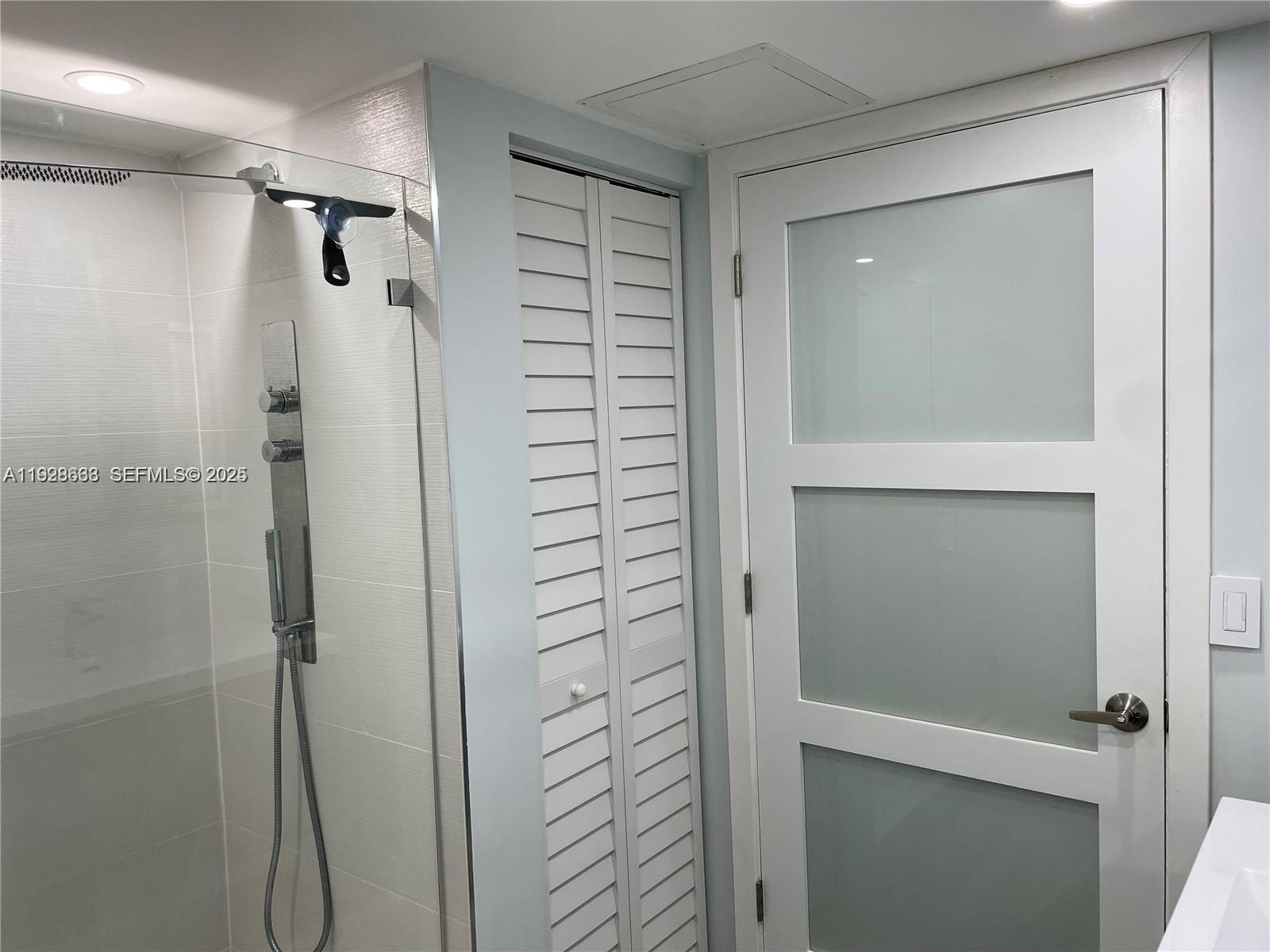 2031 Renaissance Boulevard, Unit 101 Miramar, FL 33025 - Photo 18 of 23 a bathroom with a shower and a glass door