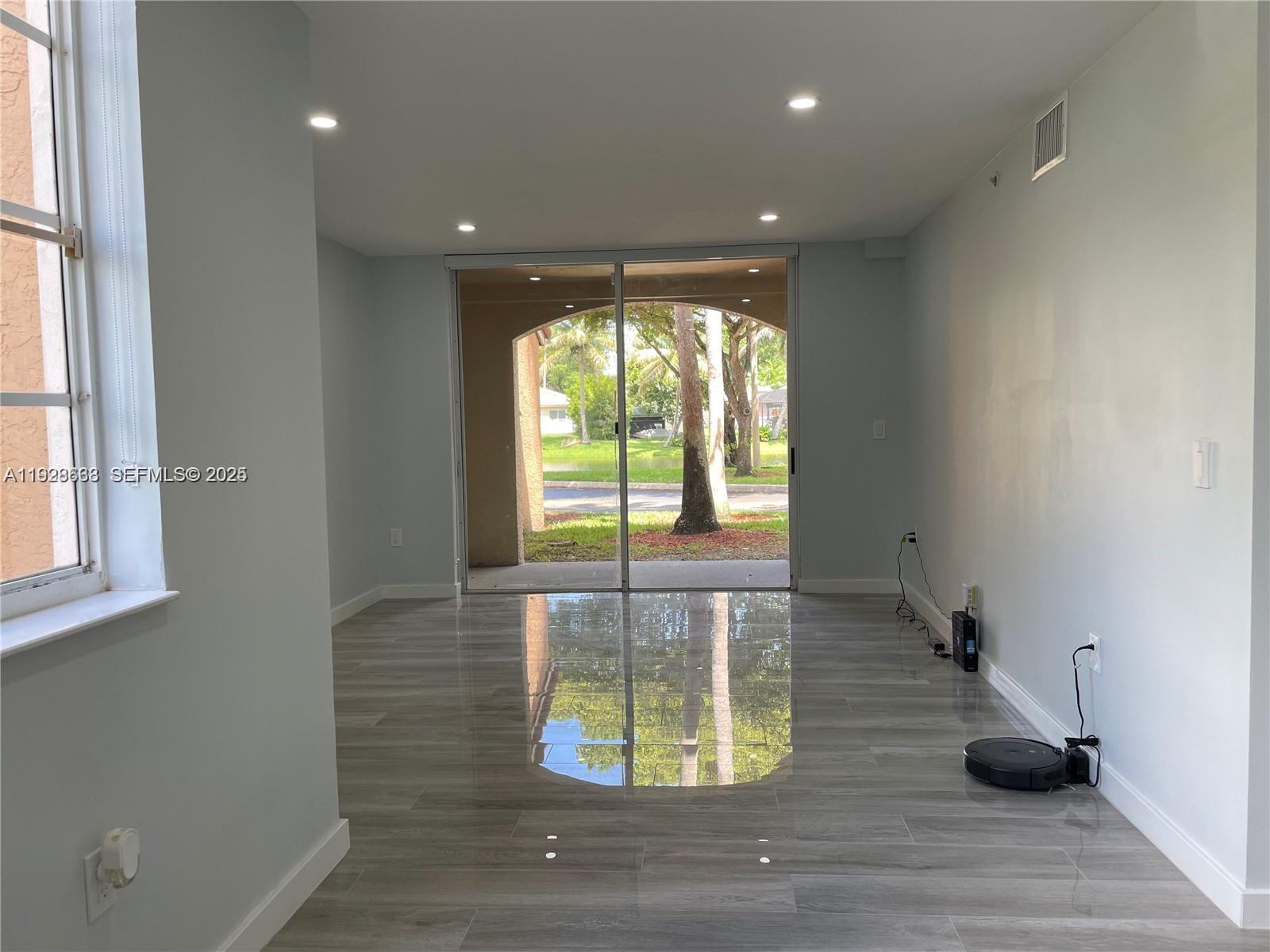 2031 Renaissance Boulevard, Unit 101 Miramar, FL 33025 - Photo 8 of 23 a view of entryway with wooden floor
