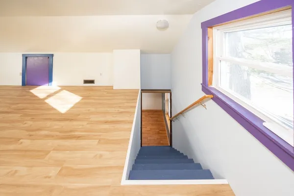 a living room with wooden floor and furniture
