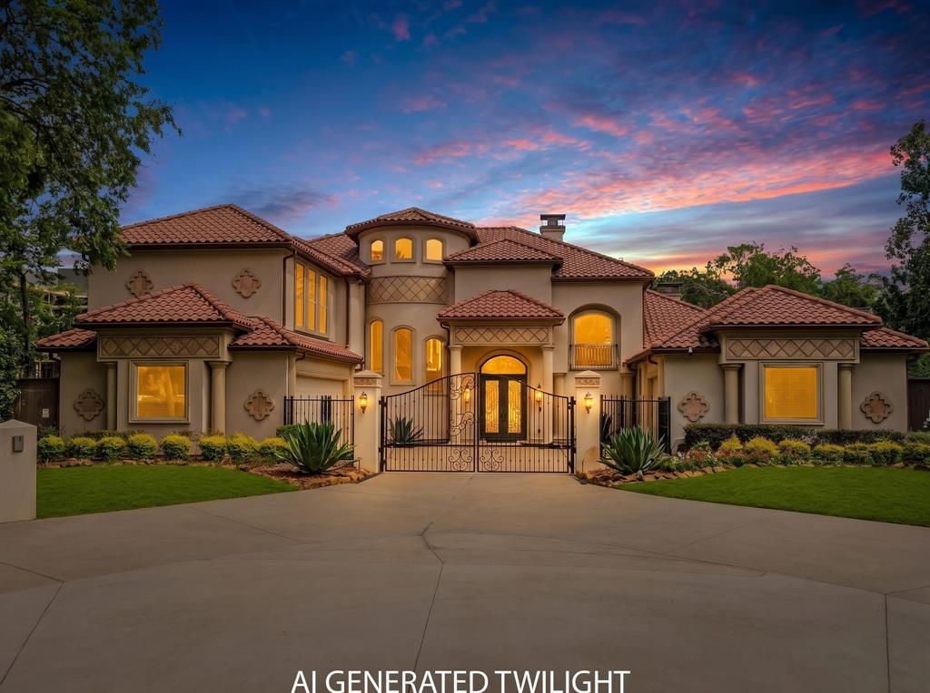 5821 Northaven Road Dallas, TX 75230 - Photo 40 of 40 Mediterranean-style exterior featuring a terracotta tile roof, stucco facade, decorative iron entry gates, a paved circular driveway, and manicured landscaping