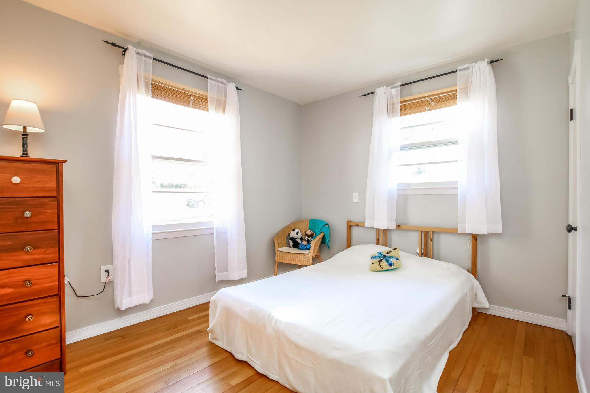 832 Templecliff Road Pikesville, MD 21208 - Photo 13 of 30 a bedroom with a bed and wooden floor