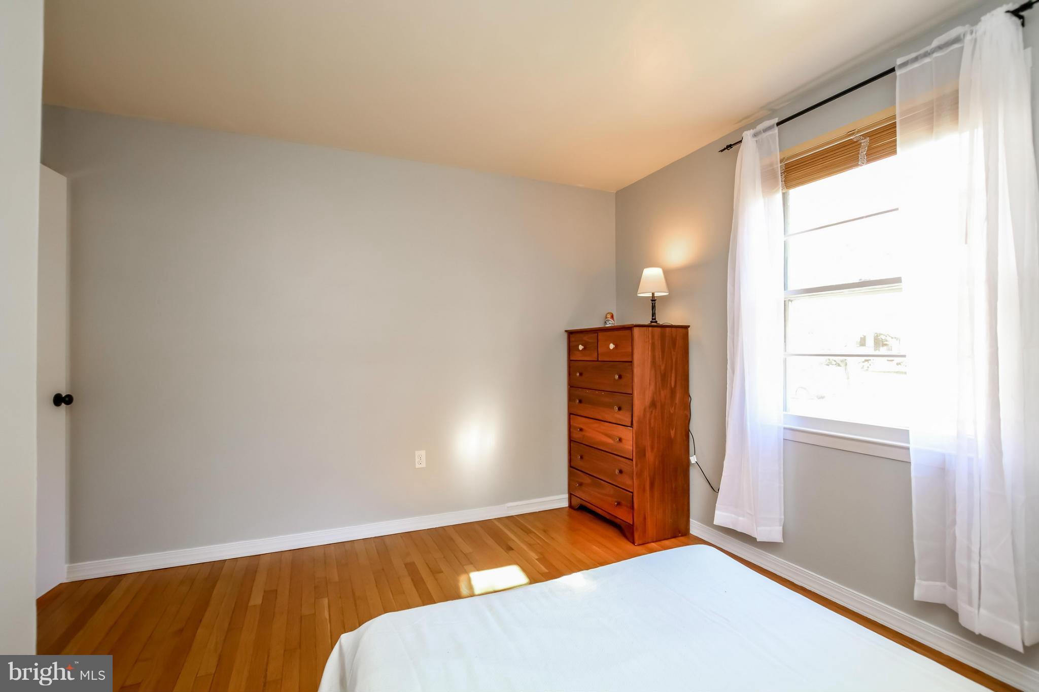 832 Templecliff Road Pikesville, MD 21208 - Photo 15 of 30 a bedroom with a bed and wooden floor