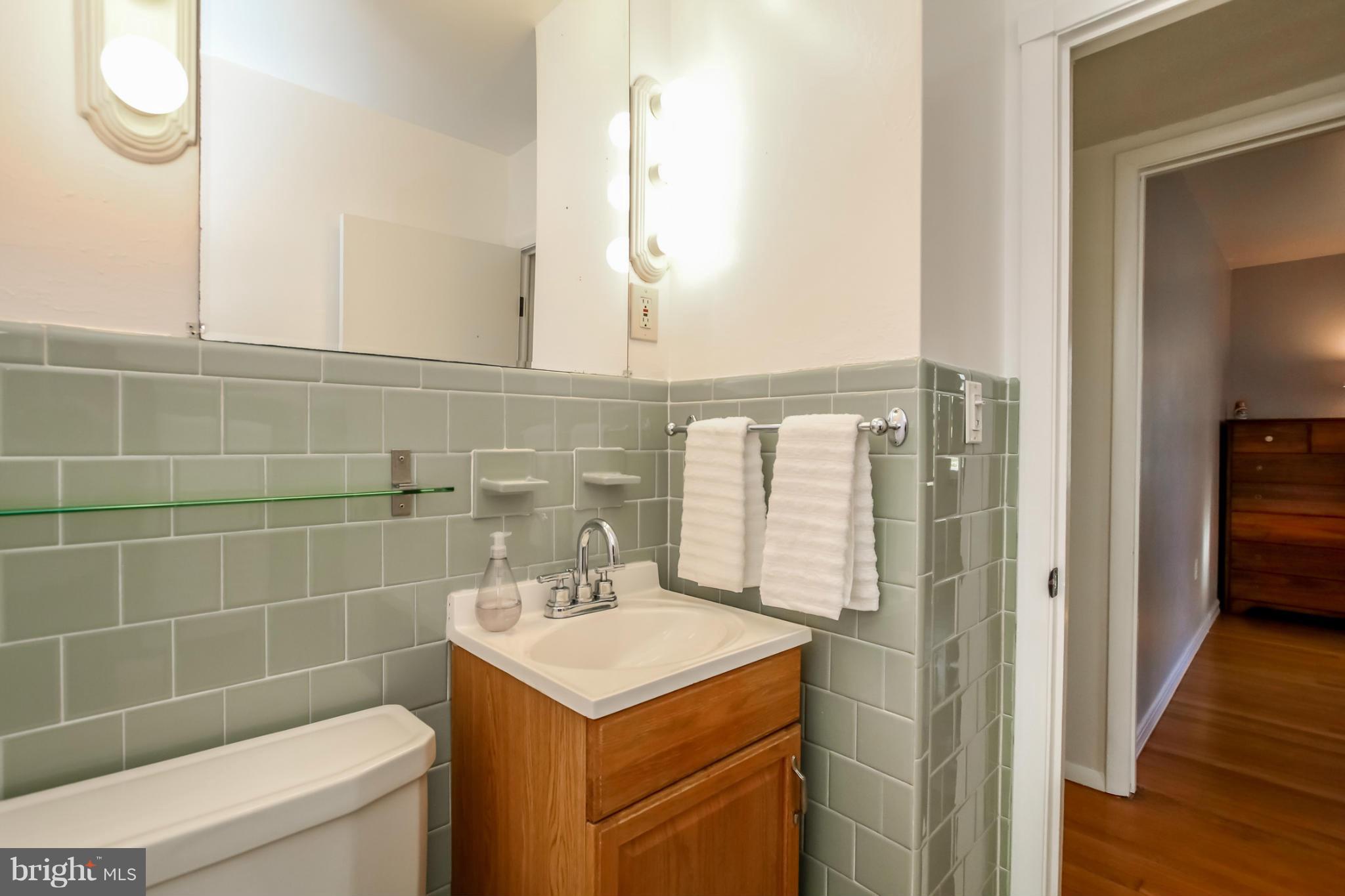 832 Templecliff Road Pikesville, MD 21208 - Photo 17 of 30 a bathroom with a sink a toilet and shower