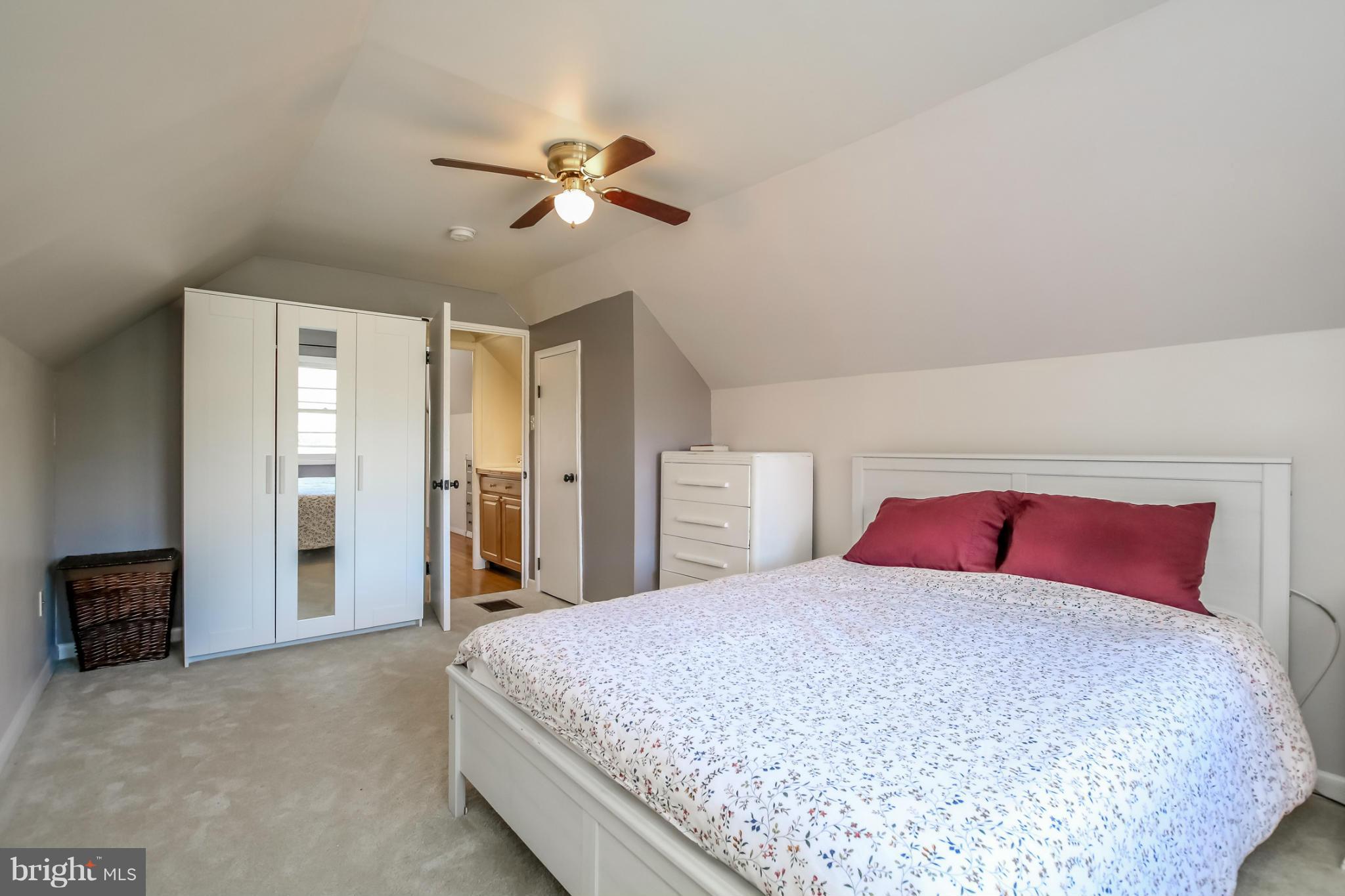 832 Templecliff Road Pikesville, MD 21208 - Photo 22 of 30 a bedroom with a large bed and a chandelier