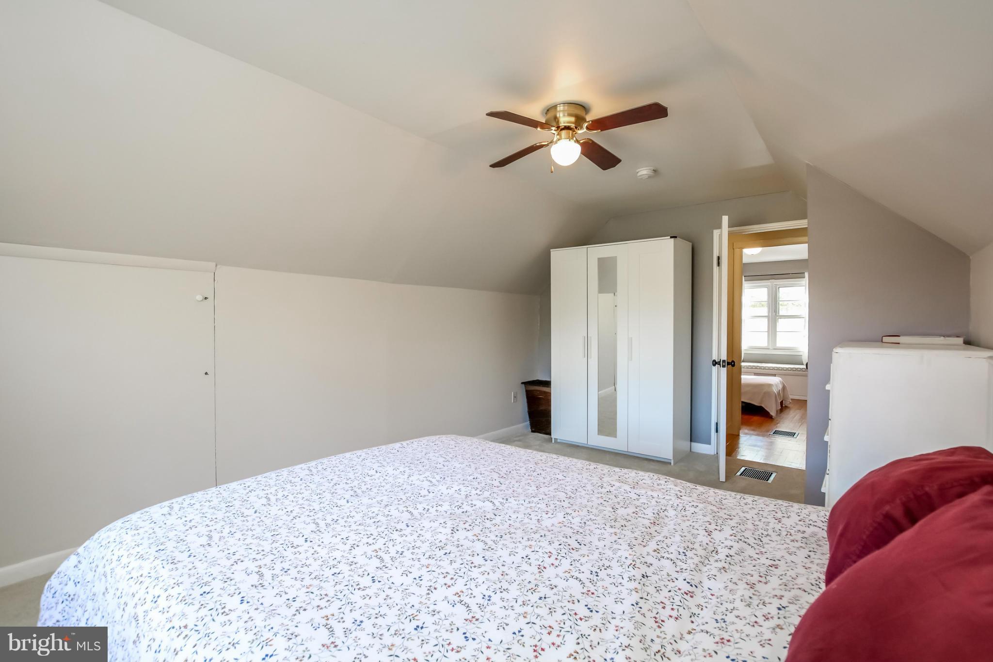 832 Templecliff Road Pikesville, MD 21208 - Photo 23 of 30 a bedroom with a bed and a chandelier