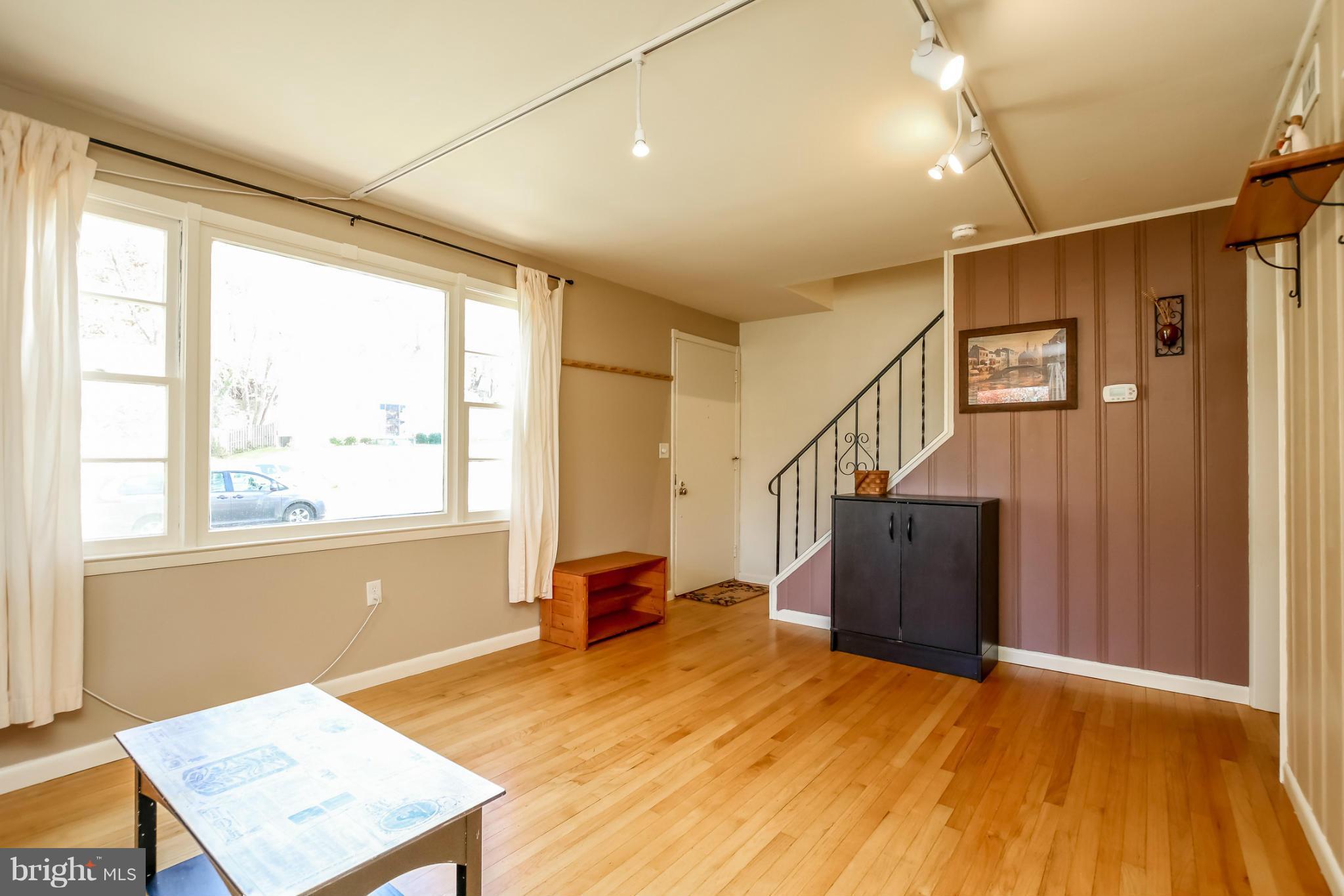 832 Templecliff Road Pikesville, MD 21208 - Photo 6 of 30 a view of an empty room with a window and wooden floor