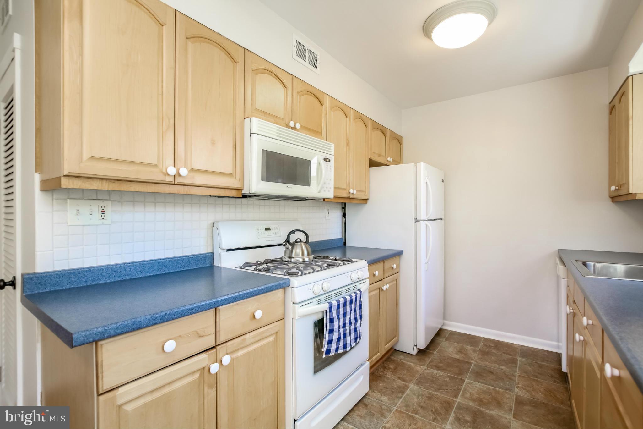 832 Templecliff Road Pikesville, MD 21208 - Photo 10 of 30 a kitchen with stainless steel appliances granite countertop a stove a refrigerator and a cabinets