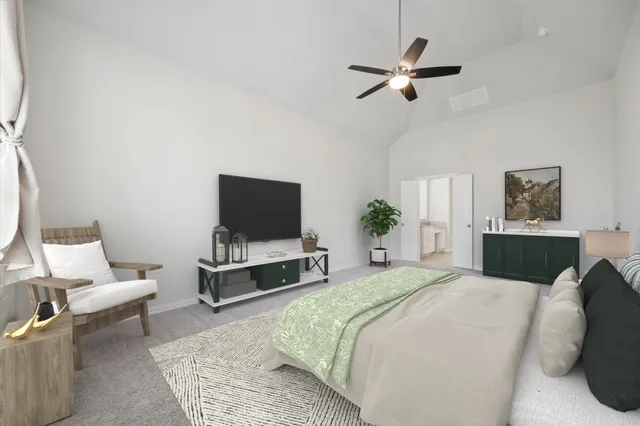 a bedroom with a bed a couch and a flat screen tv