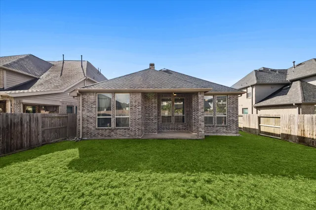a view of a house with a yard and sitting area