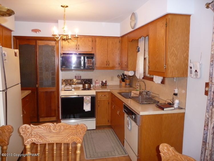 9 Old Stagecoach Road Gilbert, PA 18331 - Photo 5 of 12 a kitchen with stainless steel appliances a sink stove and refrigerator