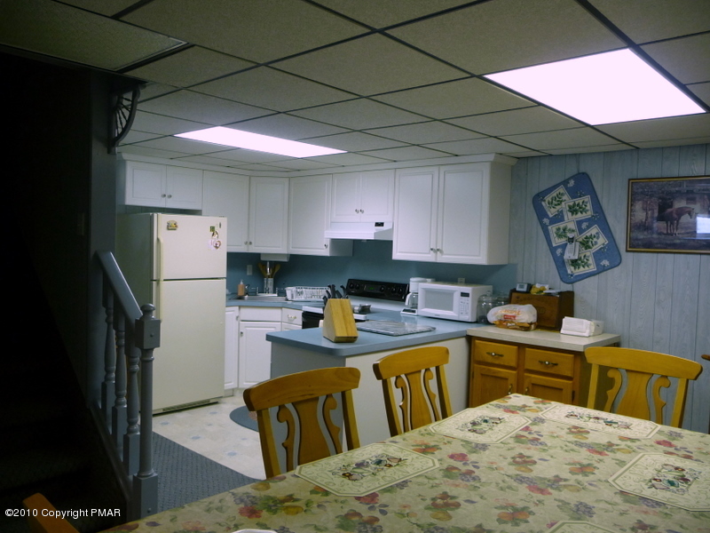 9 Old Stagecoach Road Gilbert, PA 18331 - Photo 10 of 12 a kitchen with stainless steel appliances granite countertop a sink dishwasher stove top oven and cabinets with wooden floor