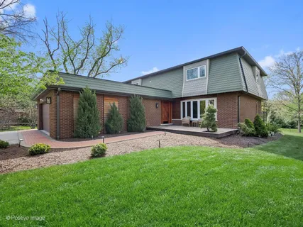 a house that has a big yard and large trees