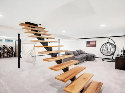a living room with furniture a rug and white walls