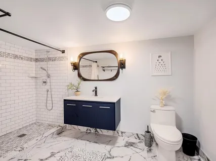 a bathroom with a toilet a sink and mirror