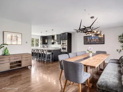 a view of a dining room with furniture and wooden floor