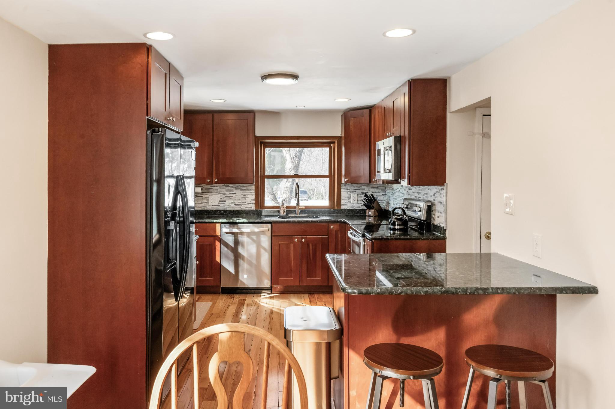 531 Gilbert Street Media, PA 19063 - Photo 14 of 45 a kitchen with kitchen island granite countertop wooden cabinets and stainless steel appliances